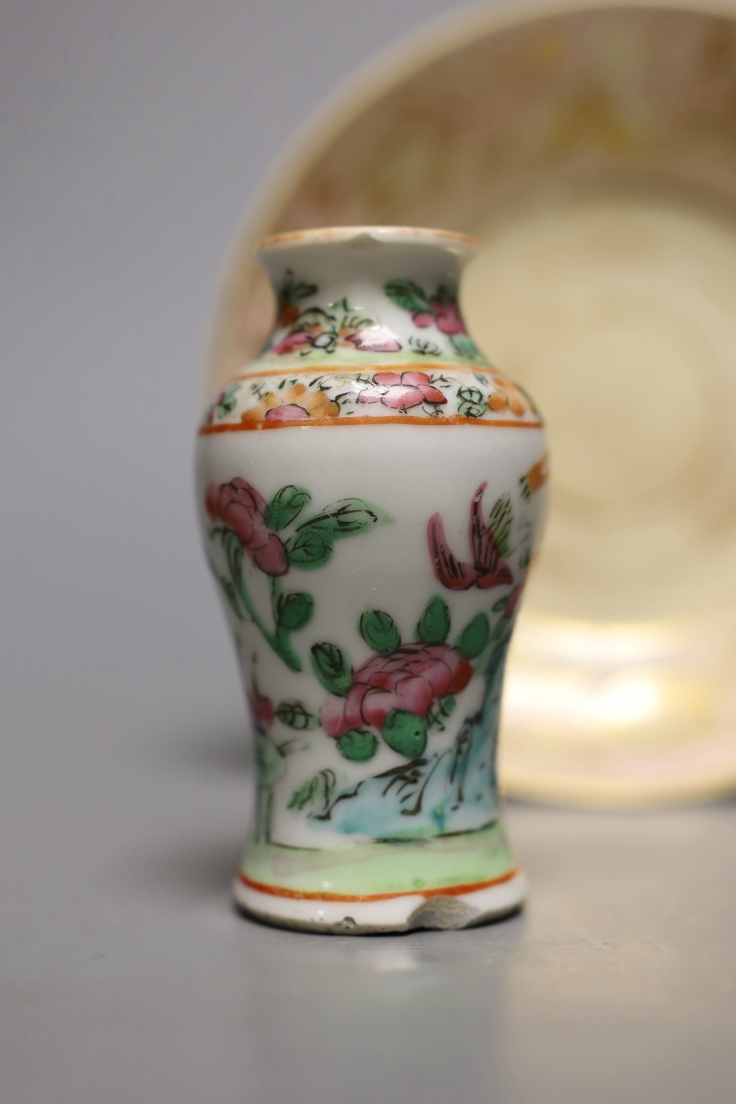 A Chinese famille rose tea bowl, similar small vase and a London shape coffee cup and saucer